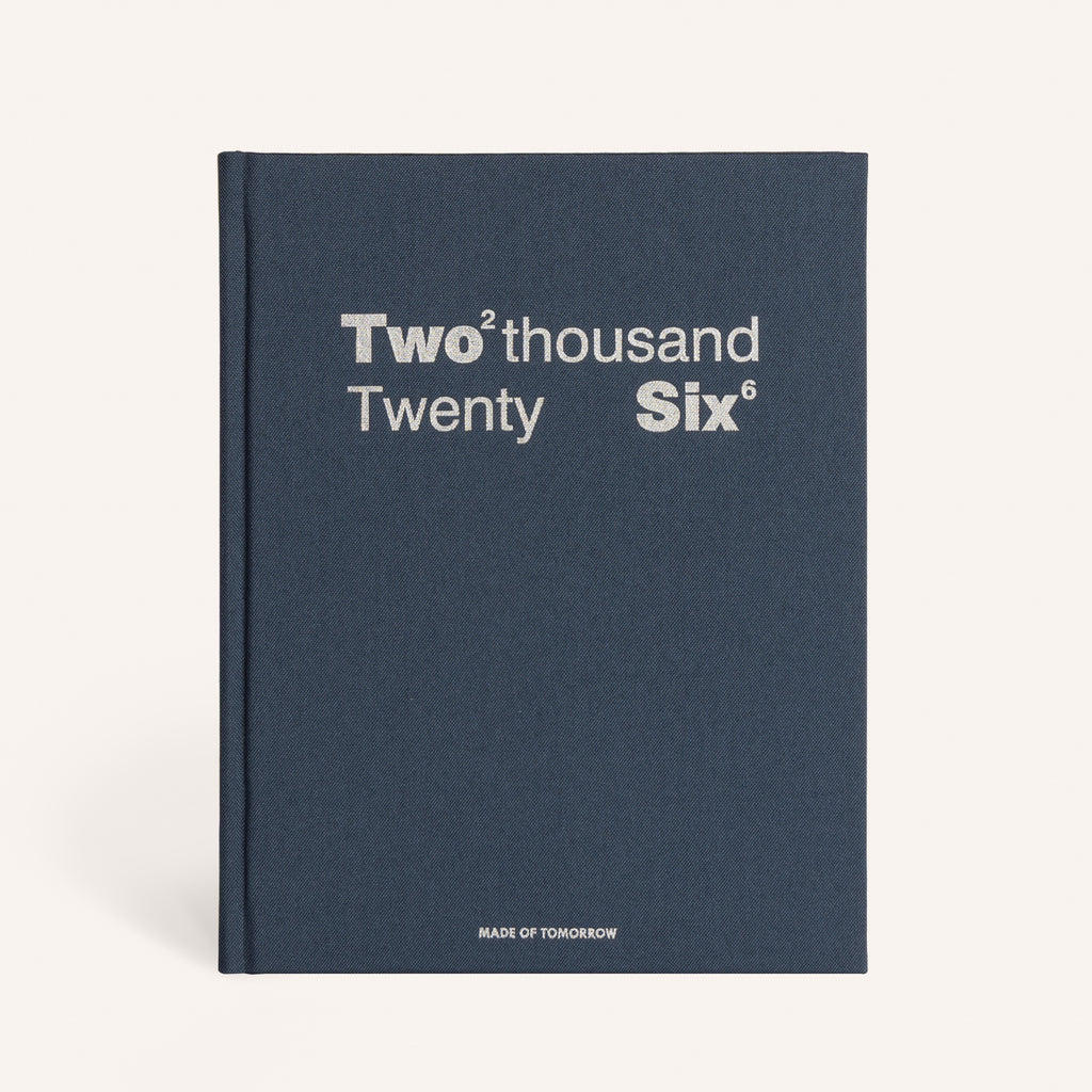 Navy blue book with 'Two thousand Twenty Six' text on a white background