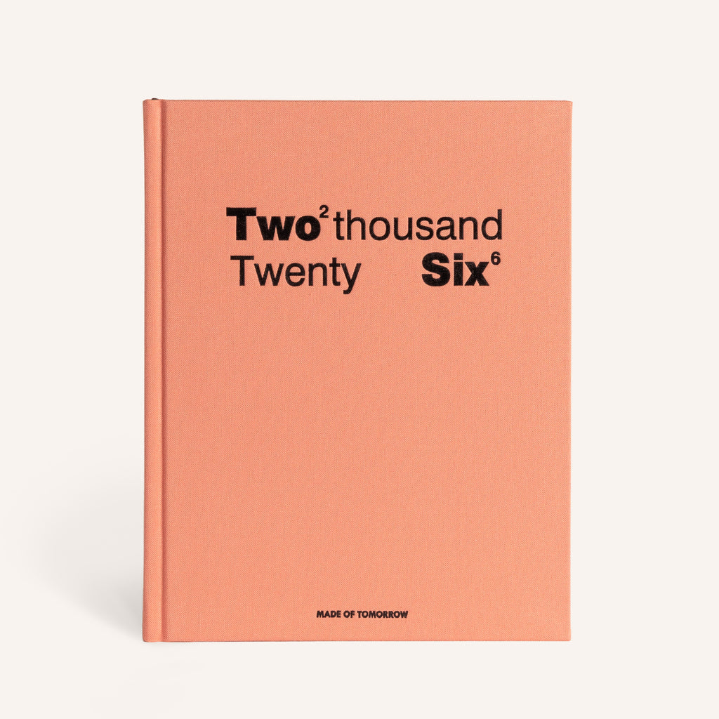Peach-colored book with 'Two thousand Twenty Six' text on a white background