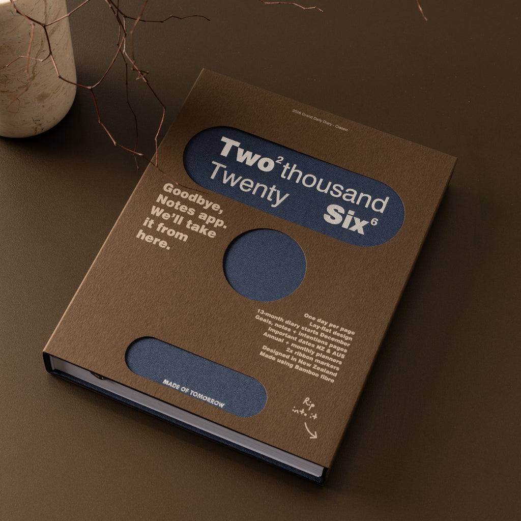 Brown book with blue circular design on a brown surface