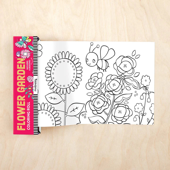 Coloring book with floral designs on a wooden surface