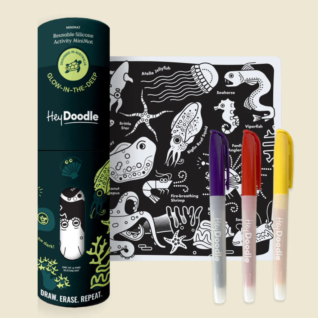 HeyDoodle product set with coloring book and markers on a beige background