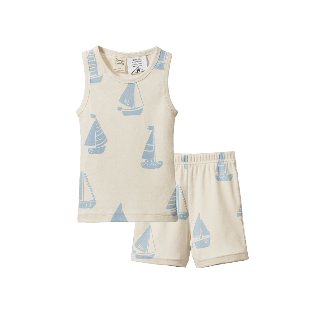 Children's sleeveless top and shorts set with sailboat pattern on a white background
