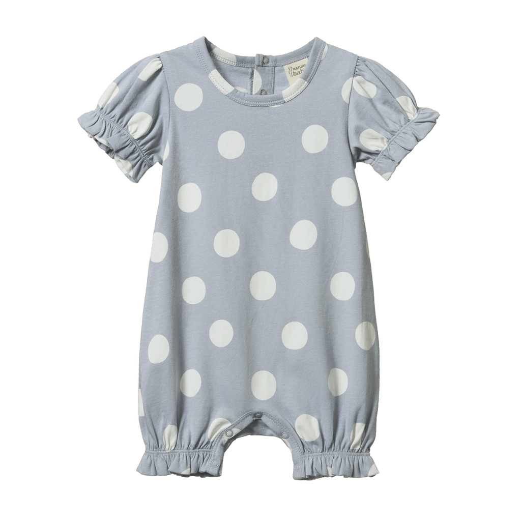 Baby romper with white polka dots on a light blue background
