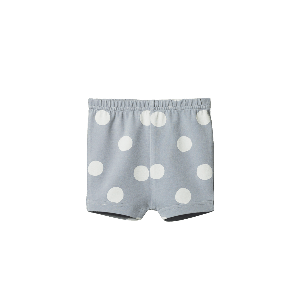 Light blue shorts with white polka dots on a white background