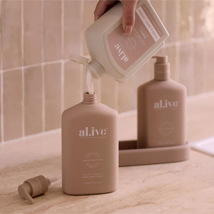 Person pouring a product into an 'alive' bottle with another 'alive' bottle in the background.