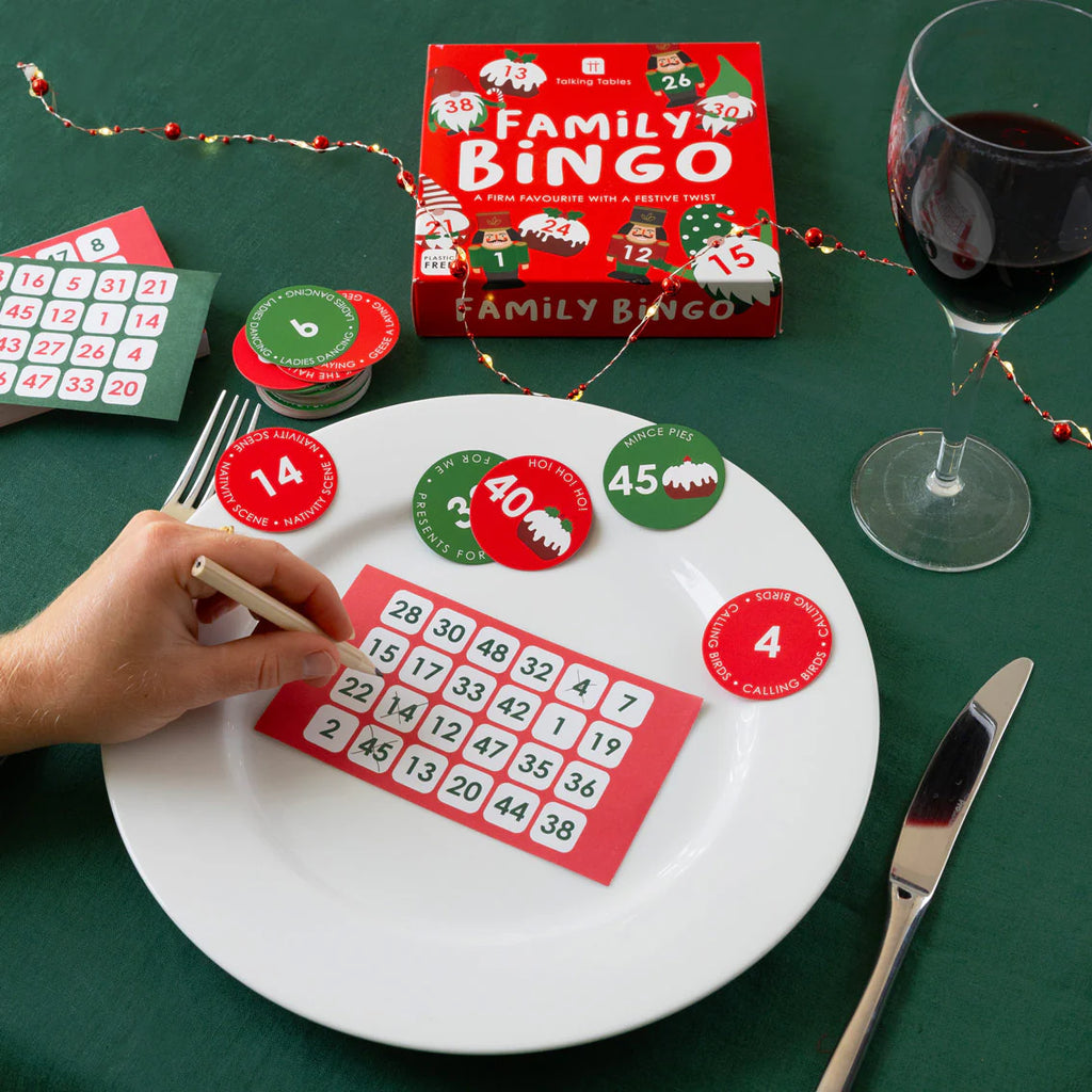 Family bingo game on a table with wine and festive decorations