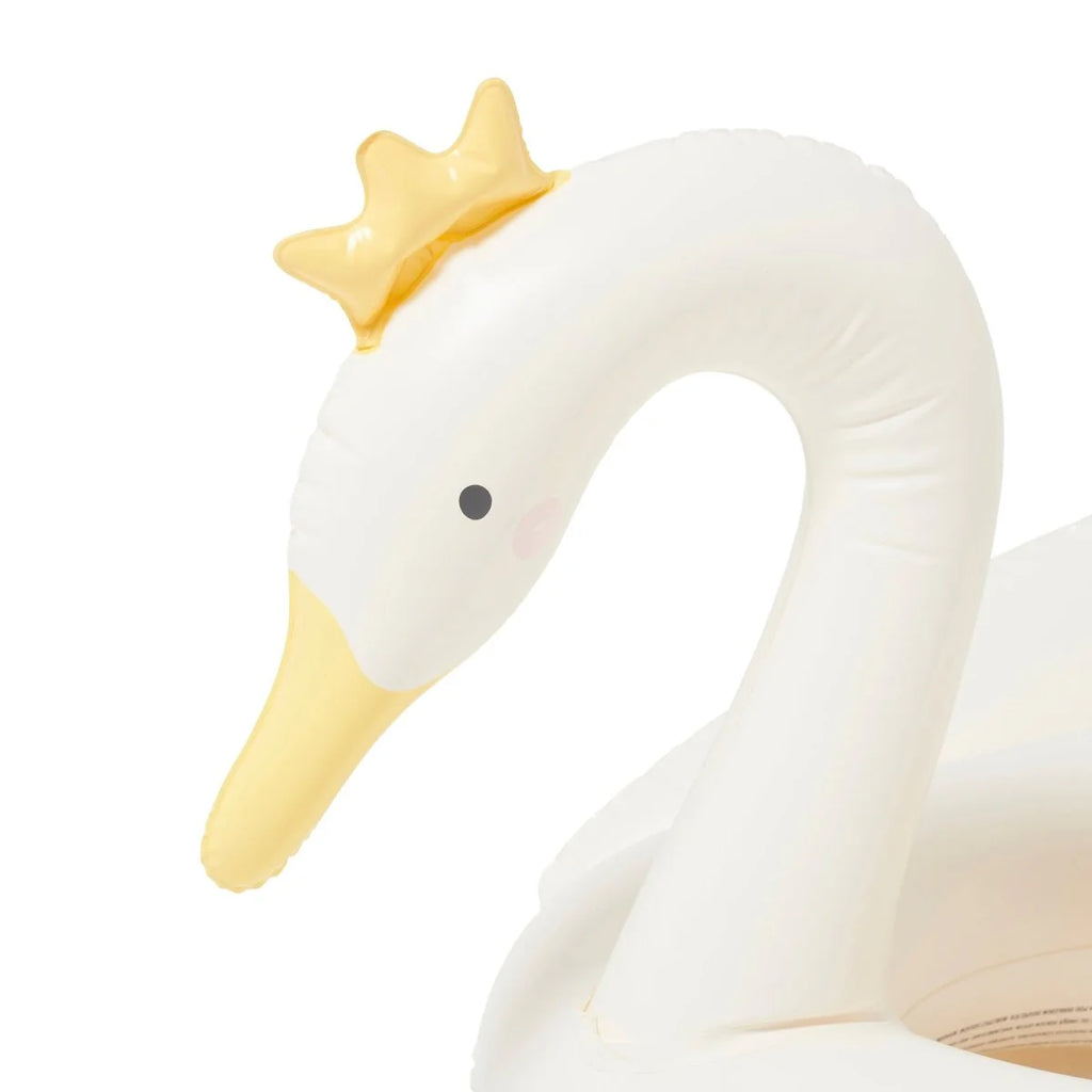 Close-up of a white swan with a yellow crown on a white background