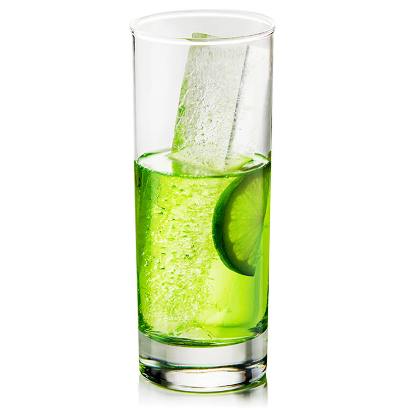 Clear glass with green liquid and a lime wedge on a white background