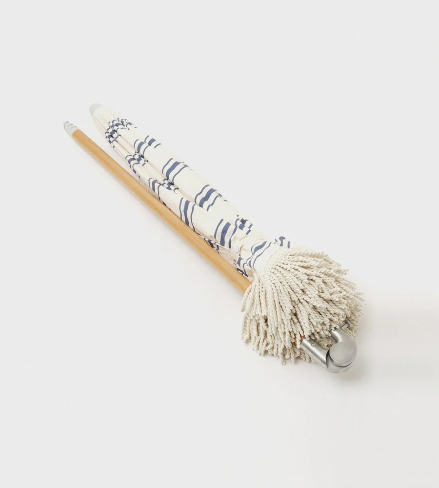 beach umbrella folded down on a white background