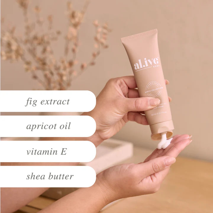 Hand holding a tube of 'alive' skincare product with ingredients listed below.