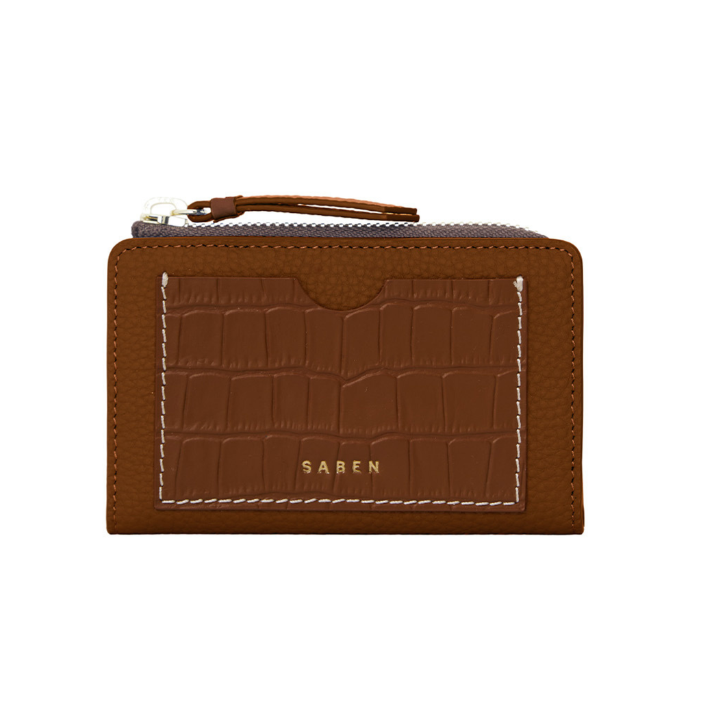 A brown leather zip wallet with a crocodile textured front compartment with gold Saben text branding and white contrast stitching