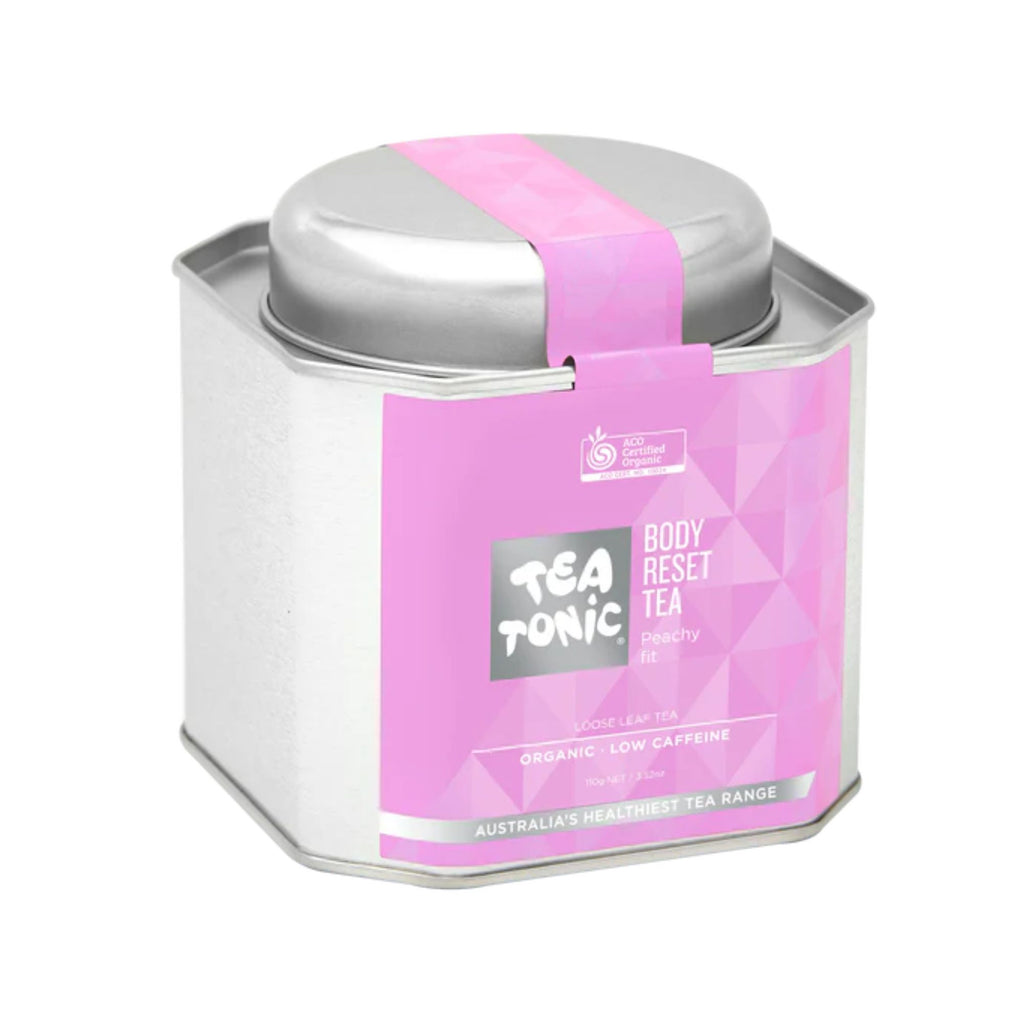 A silver tin with a lid and a purple label stating "tea tonic body reset tea"