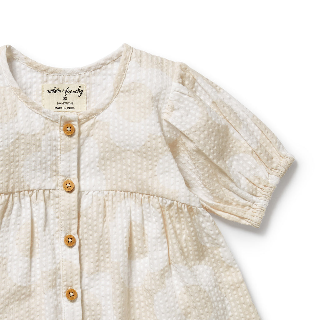 Baby dress with short sleeves and buttons on a white background
