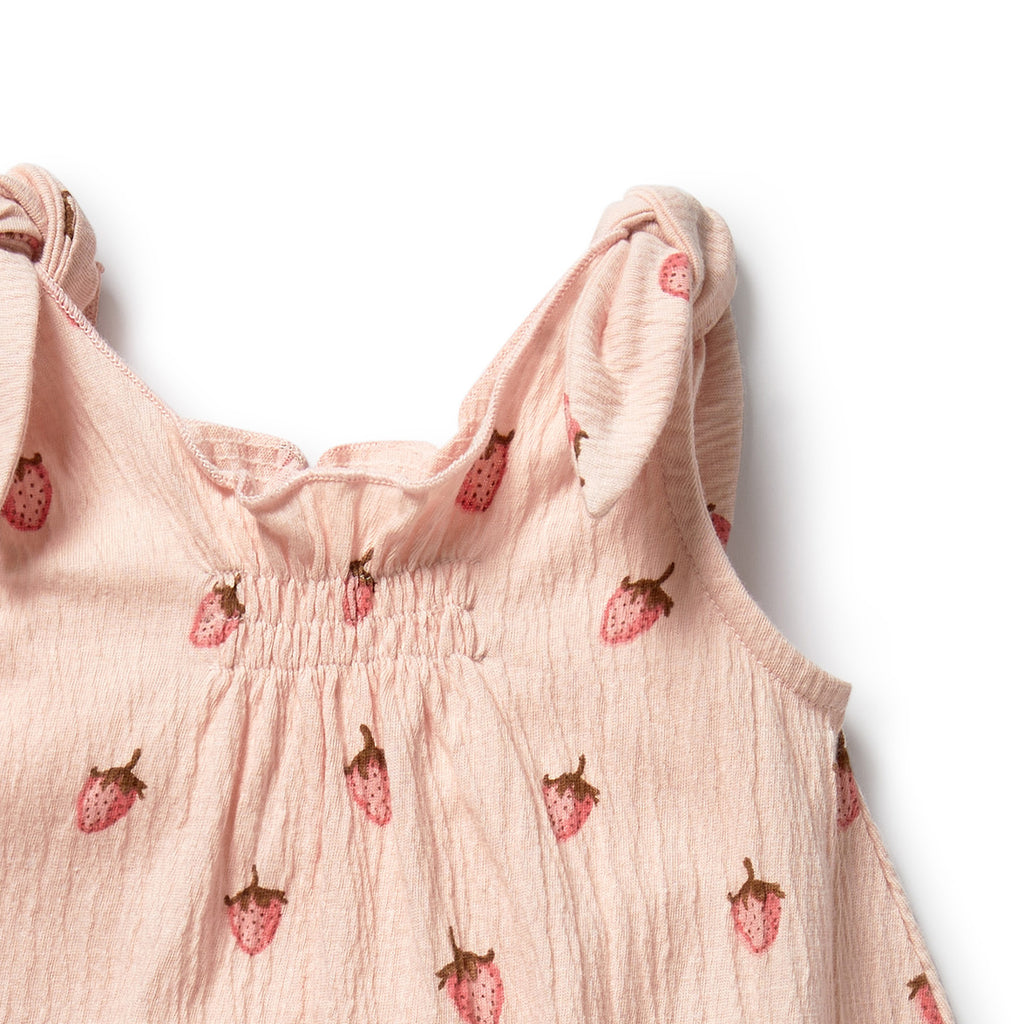 Pink sleeveless top with strawberry pattern on a white background