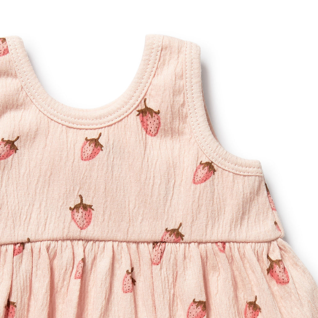 Pink dress with strawberry pattern on a white background