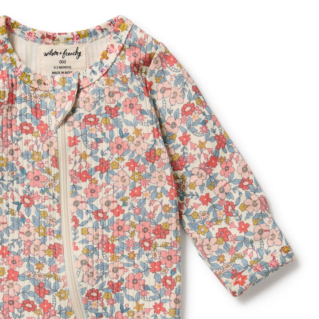 Floral-patterned baby romper with 'wilson & frenchy' branding on a white background