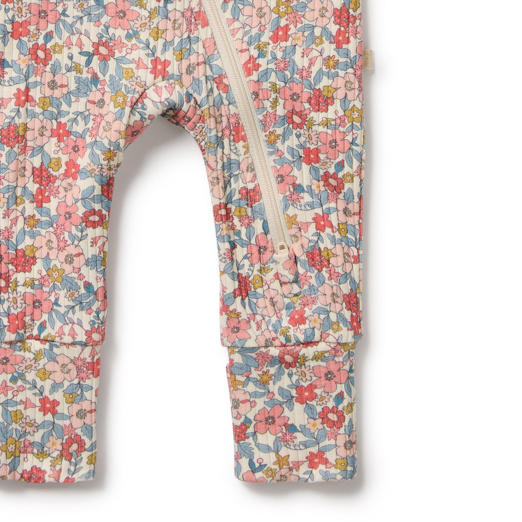 Floral-patterned baby romper on a white background