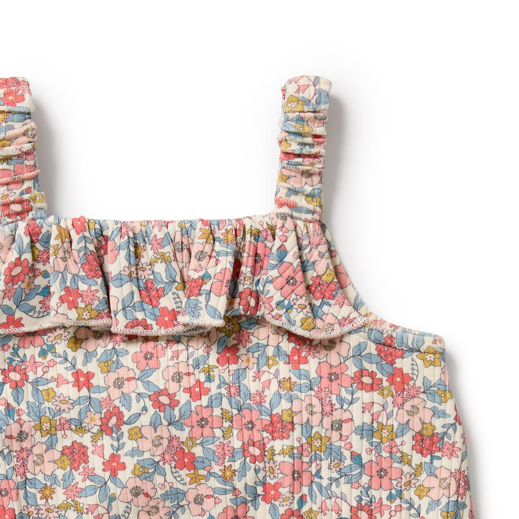 Floral patterned dress with ruffled straps on a white background