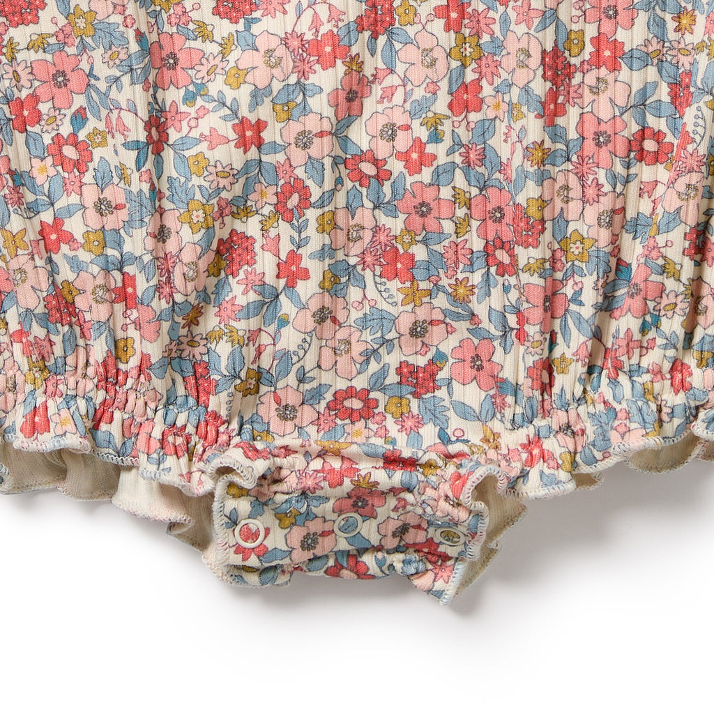 Floral patterned fabric with pink, red, and blue flowers on a white background