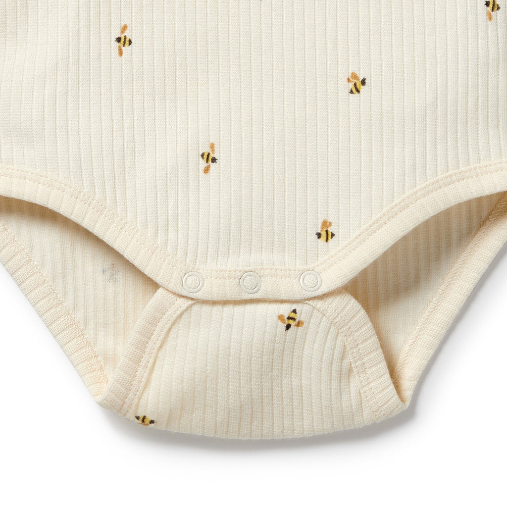 Beige baby bodysuit with bee patterns on a white background