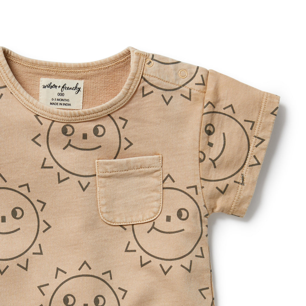 Beige baby shirt with sun pattern on a white background