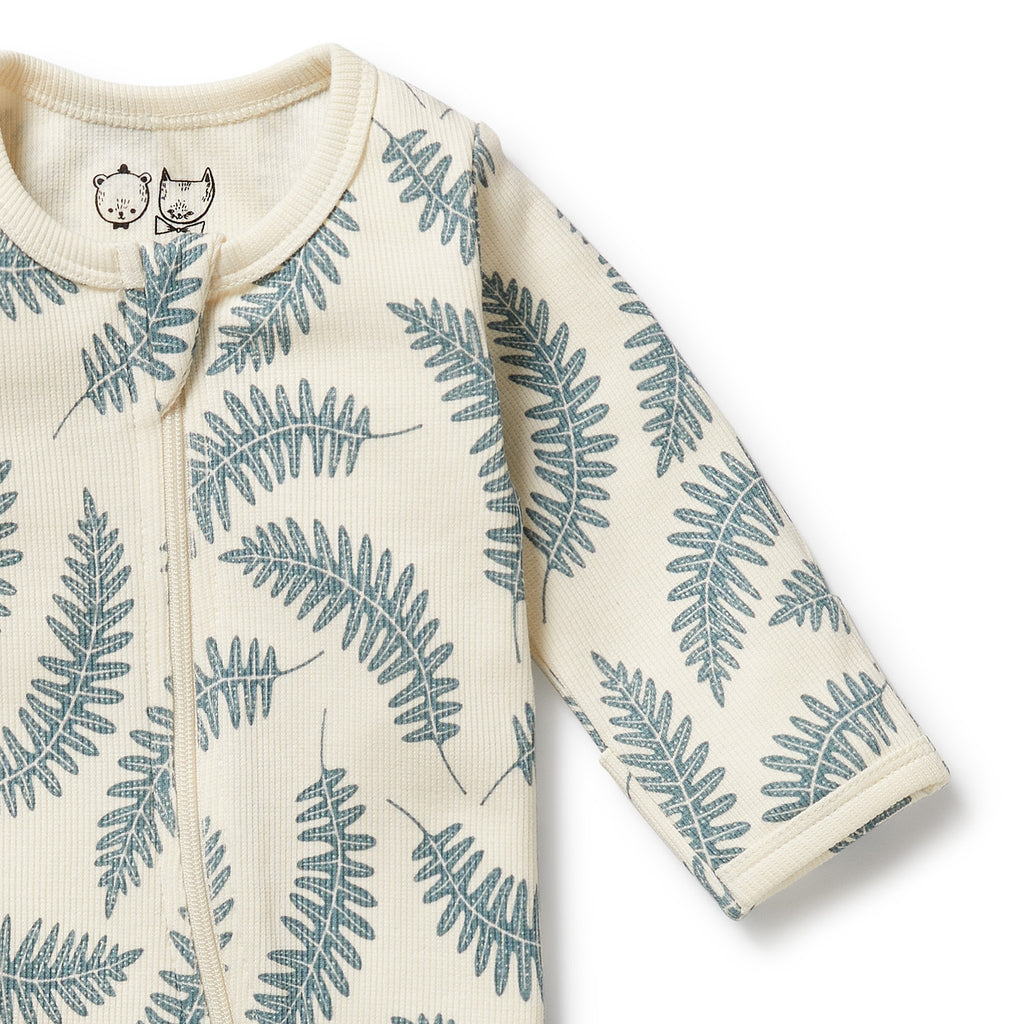 Baby onesie with fern leaf pattern on a white background
