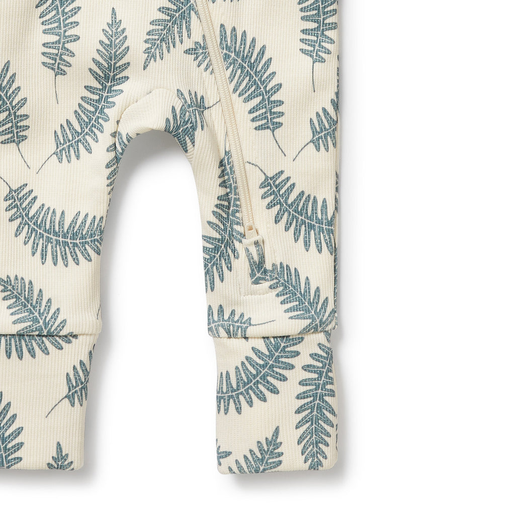 Baby romper with fern leaf pattern on a white background