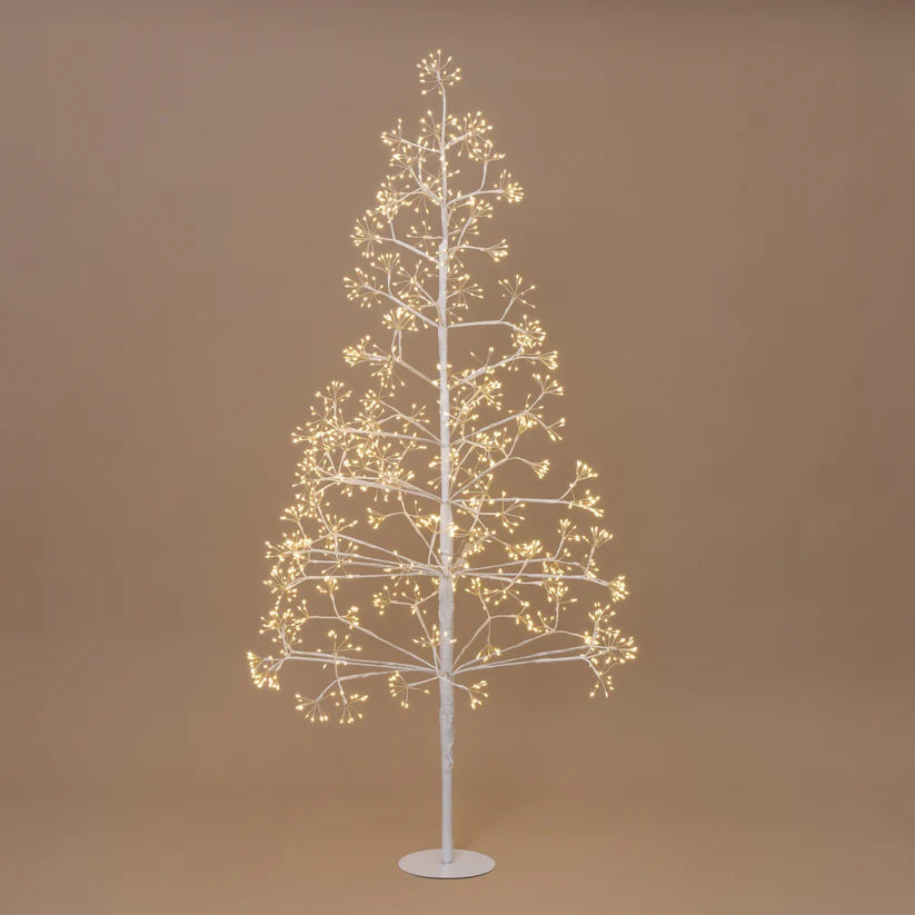 Decorative LED tree with warm white lights on a brown background