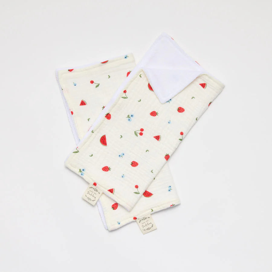 Set of two baby cloths with fruit pattern on a white background