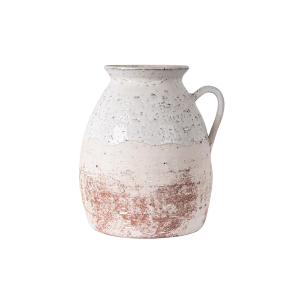 White ceramic pitcher with a textured surface on a white background