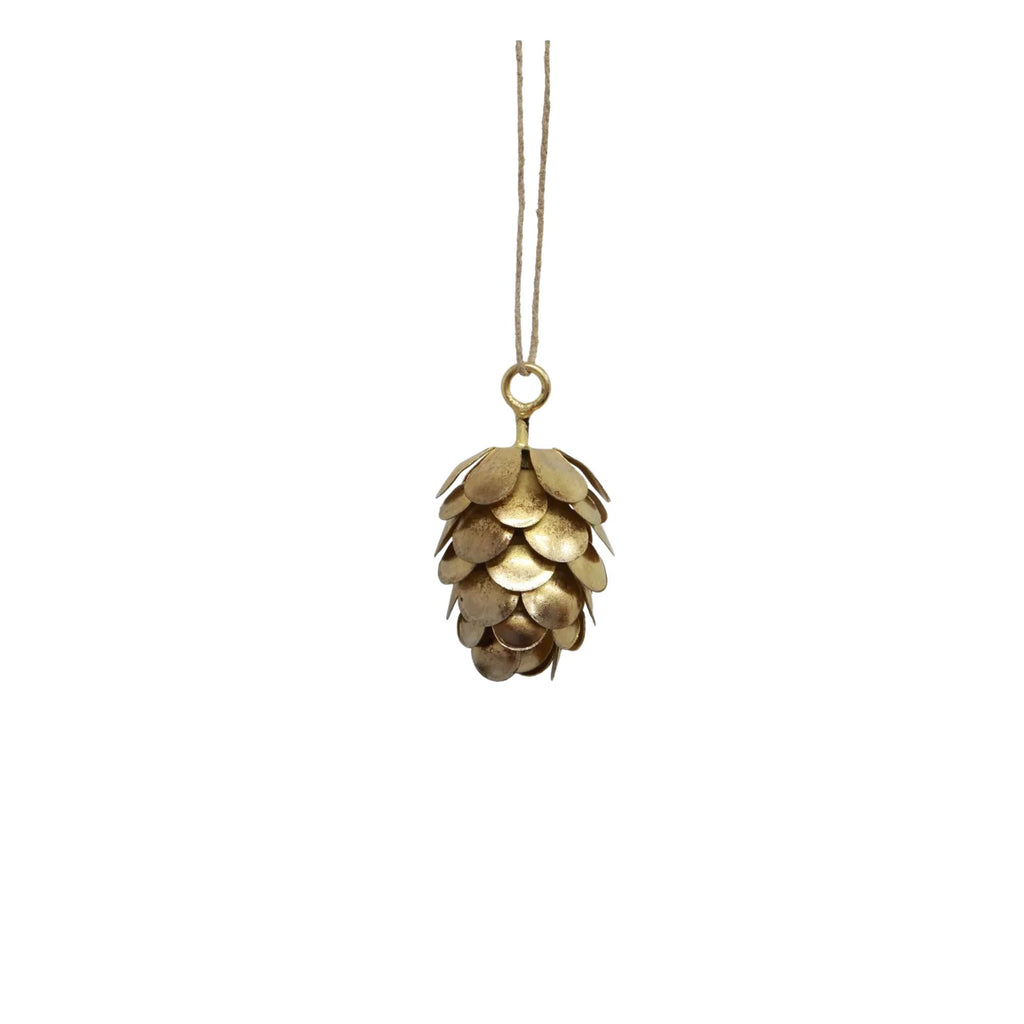 Gold pine cone ornament hanging on a white background