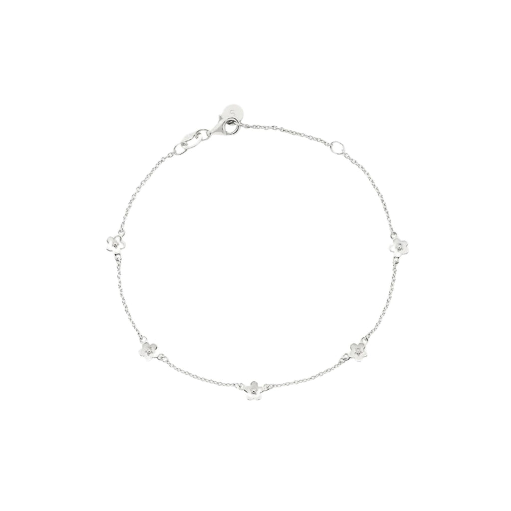 Silver bracelet with small daisies on a white background
