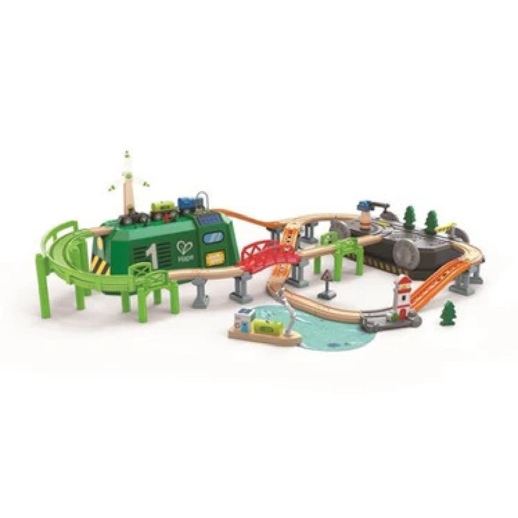 Toy train set with tracks and green engine on a white background