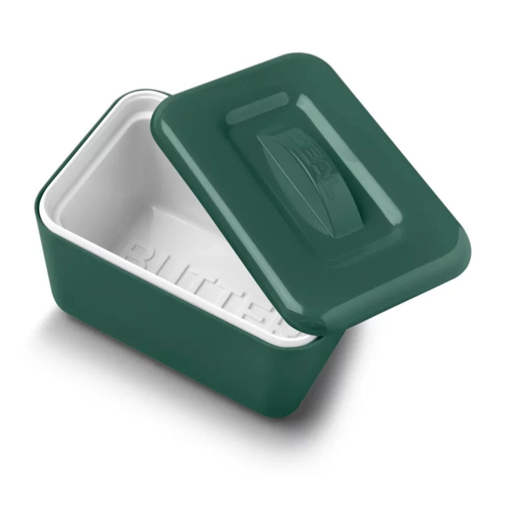 Green ceramic butter dish with lid on a white background