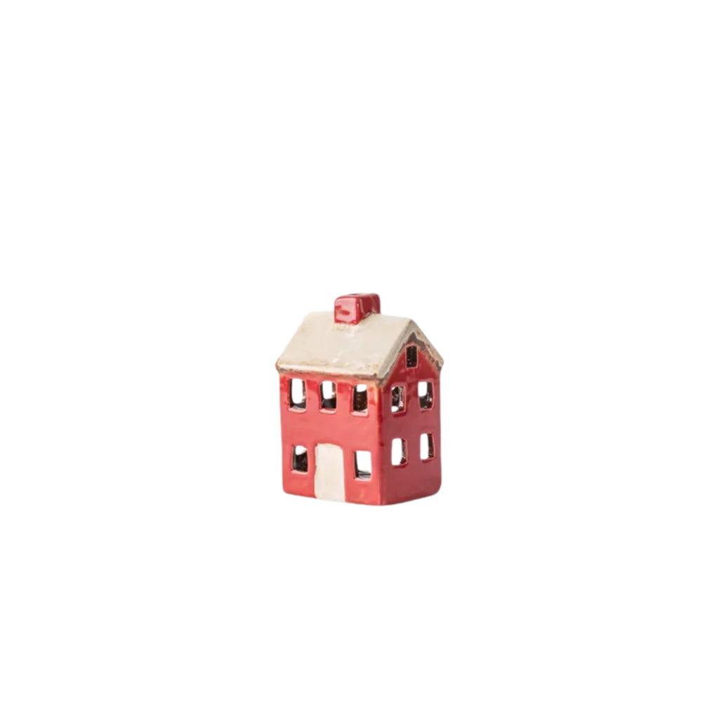 Small ceramic house-shaped object on a white background