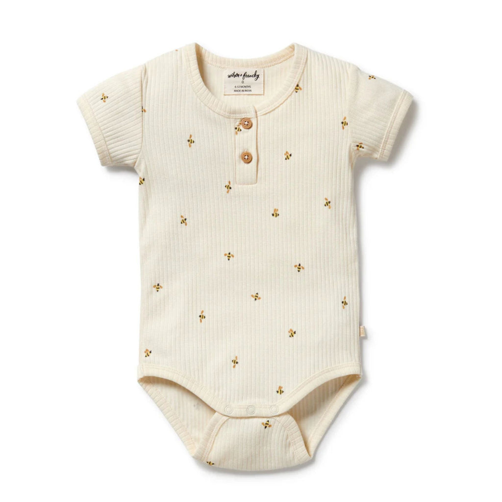 Baby onesie with gold floral patterns on a white background