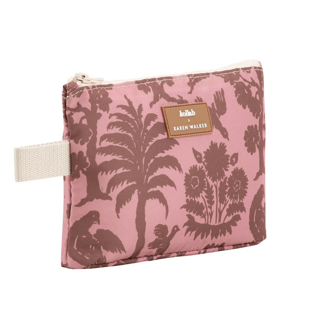 Pink pouch with floral and palm tree design, featuring a brand label.