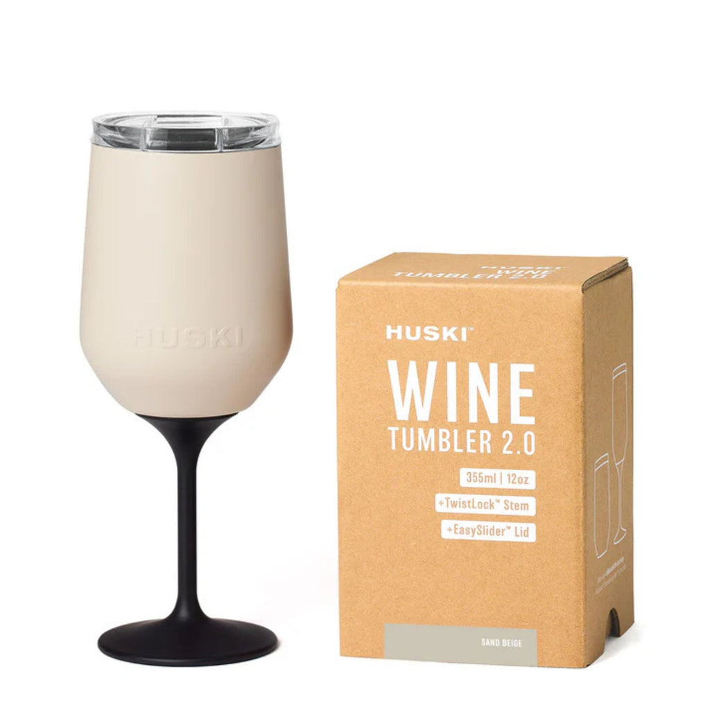 Huski Wine Tumbler 2.0 with beige tumbler and black stem next to its packaging box on a white background