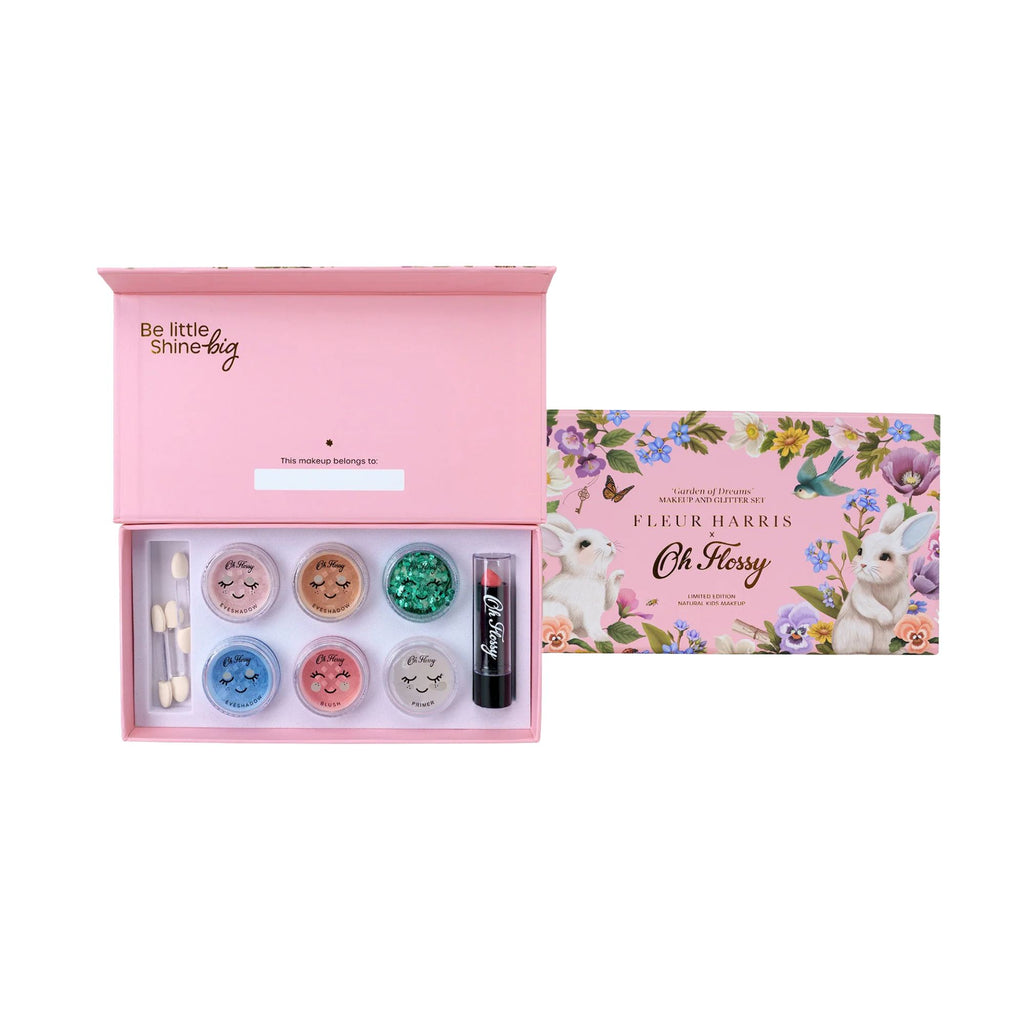 Makeup set with pink box and cosmetic items on a white background