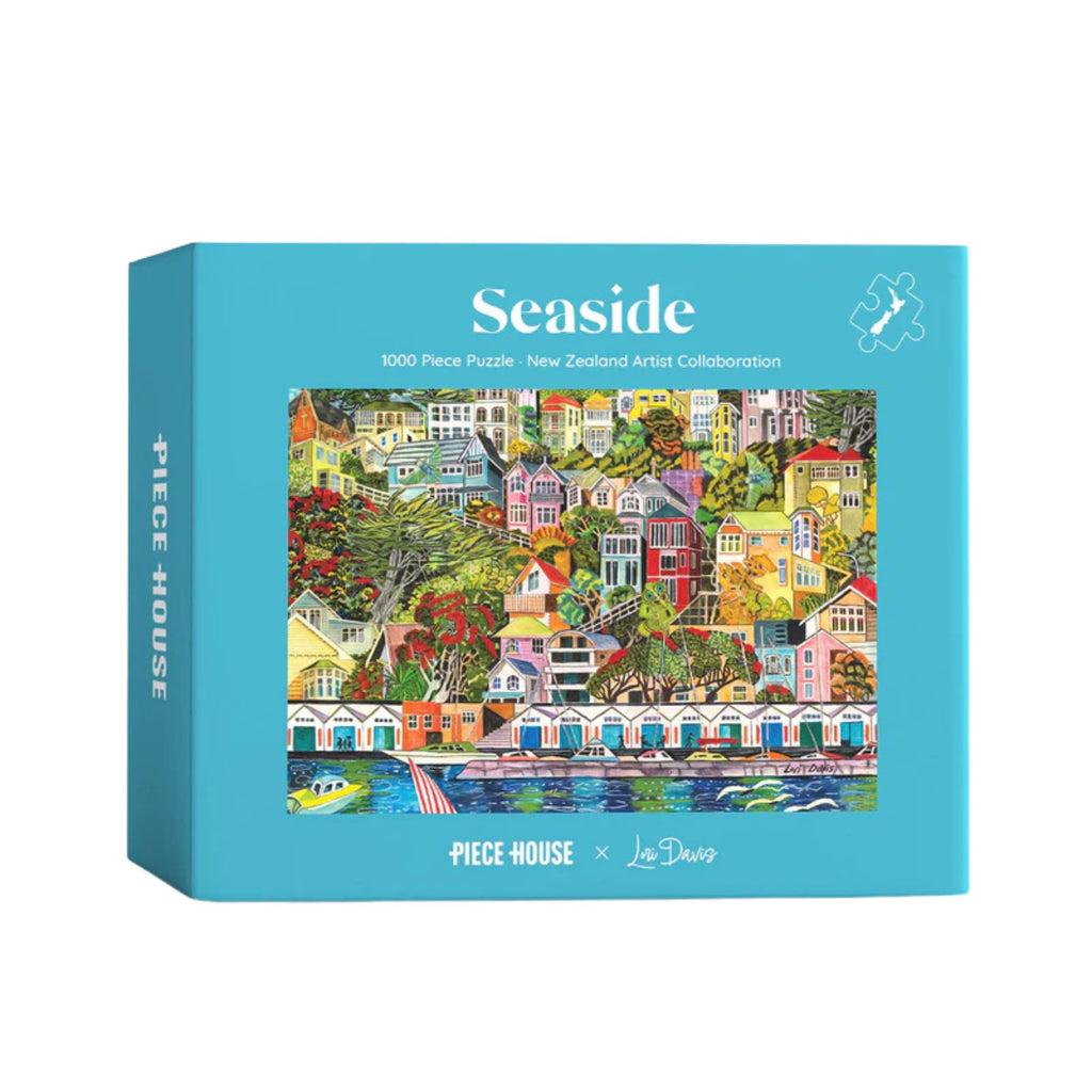 Jigsaw puzzle box with colorful seaside scene and 'Seaside' branding on a blue background