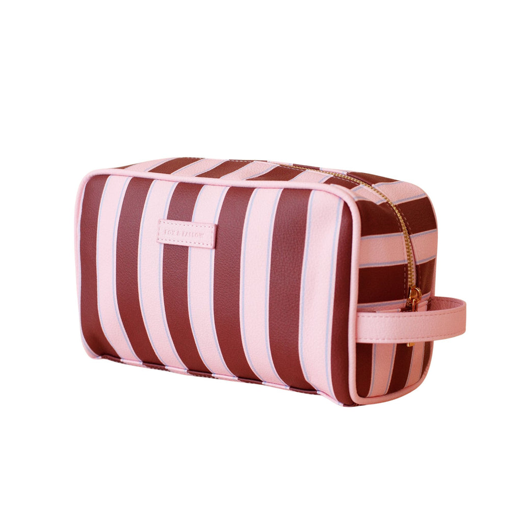 Striped toiletry bag with pink and brown stripes on a white background