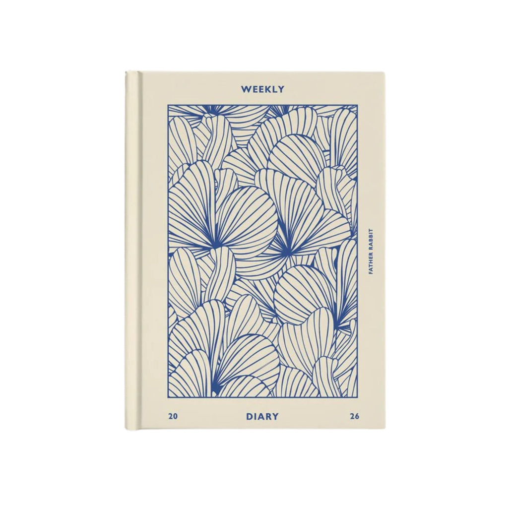 Beige diary with blue leaf pattern on a white background