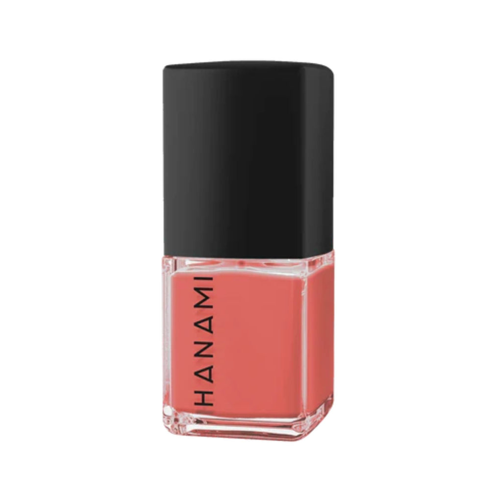 Pink nail polish bottle with black cap on a white background