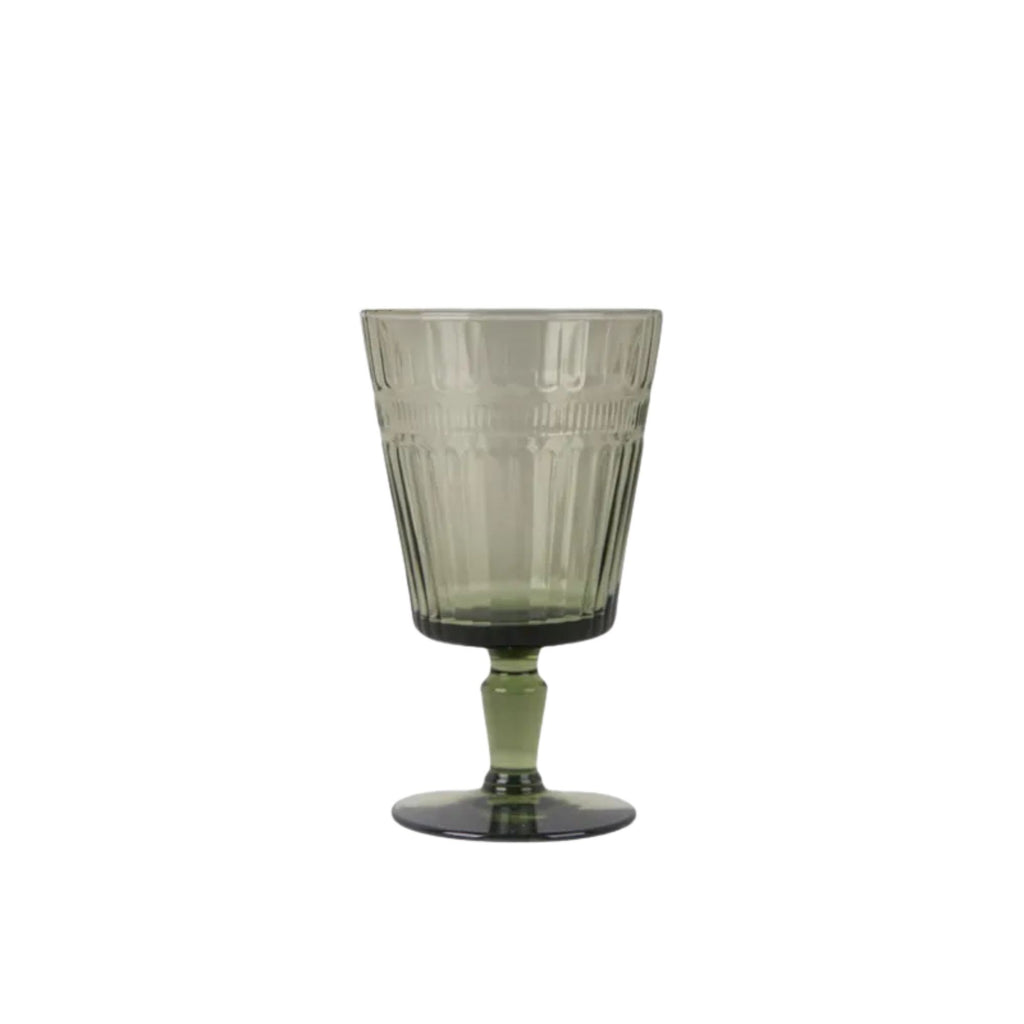 Green glass with textured design on a white background