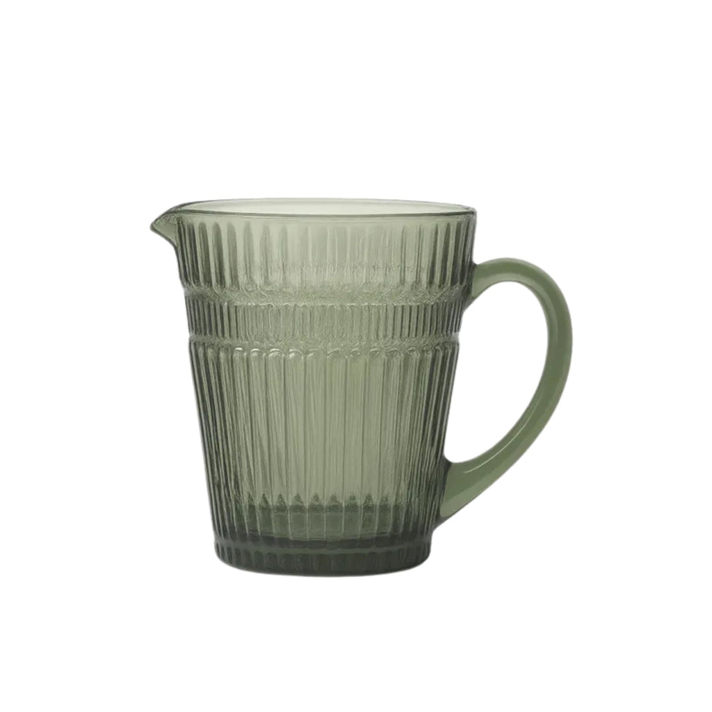 Green glass pitcher with ribbed design on a white background