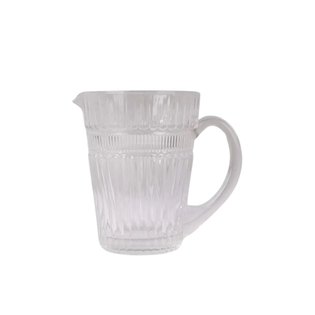 Clear glass pitcher with ribbed design on a white background