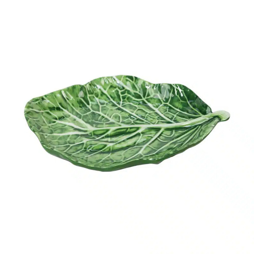 Green leaf-shaped dish on a white background