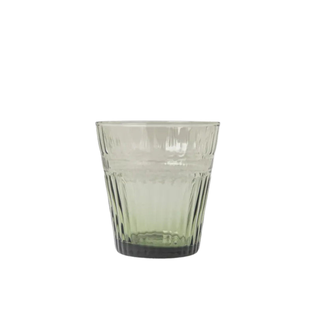 Green glass tumbler on a white background
