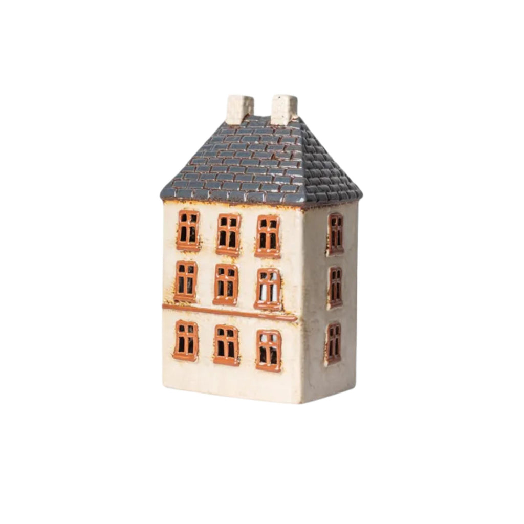 Small ceramic house model with a gray roof on a white background
