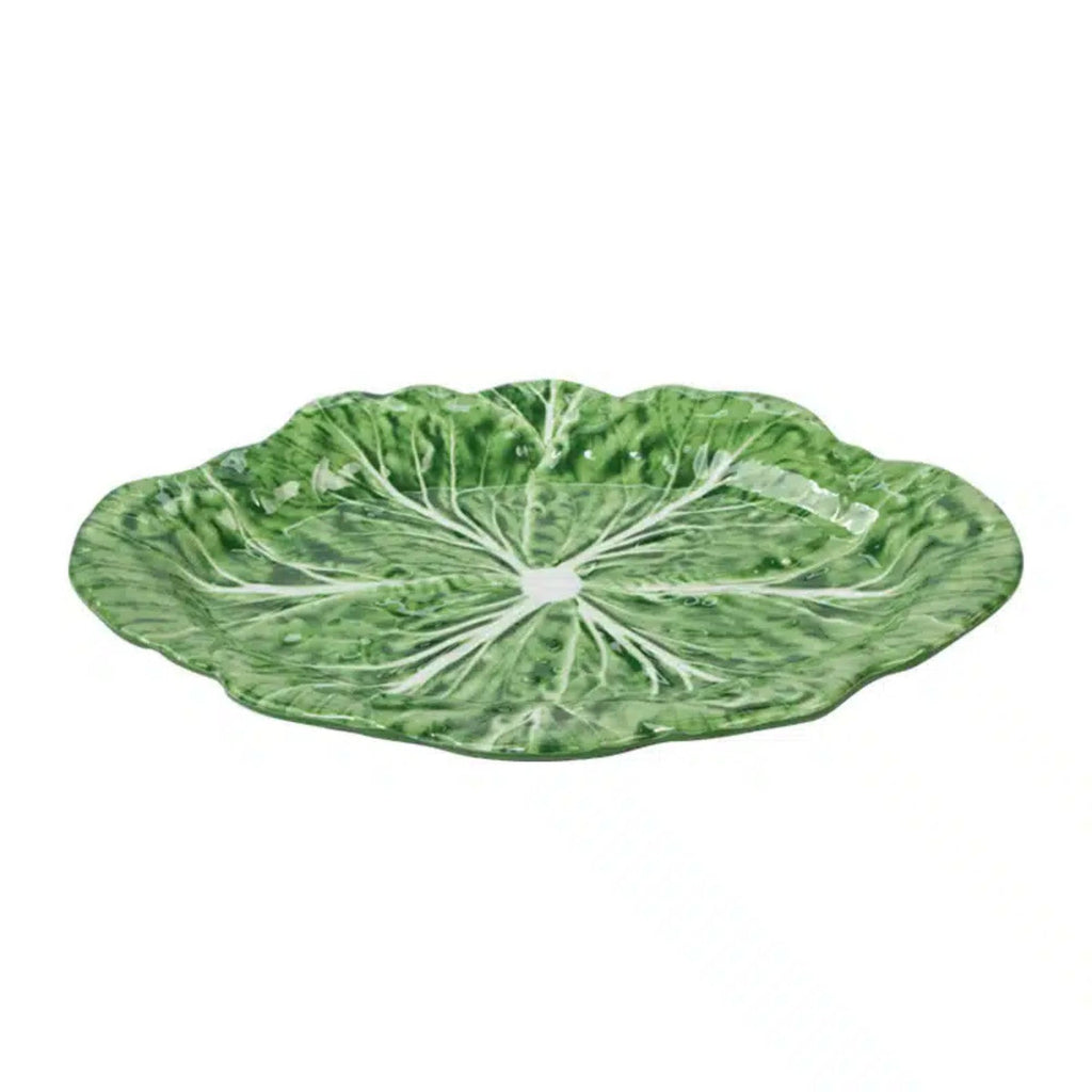 Green leaf-shaped plate on a white background